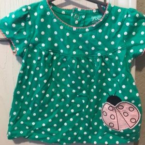 Green shirt with ladybug